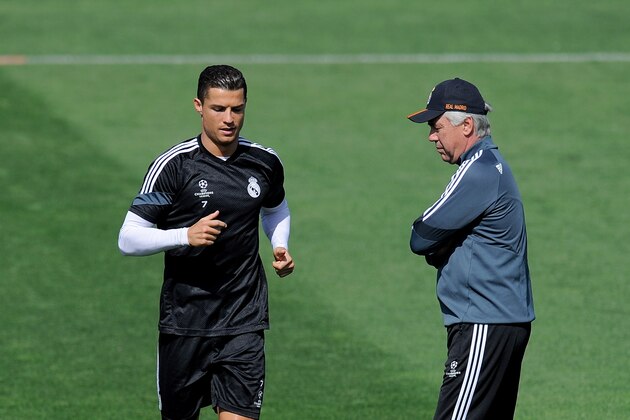 MADRID, SPAIN - MAY 12: Cristiano Ronaldo of Real Madrid runs past head coach Carlo Ancelotti during the Real Madrid CF training session ahead of the UEFA Champions League Semi Final, Second Leg against Juventus at Valdebebas training ground on May 12, 2015 in Madrid, Spain. (Photo by Denis Doyle/Getty Images) MADRID, SPAIN - MAY 12: Cristiano Ronaldo of Real Madrid runs past head coach Carlo Ancelotti during the Real Madrid CF training session ahead of the UEFA Champions League Semi Final, Second Leg against Juventus at Valdebebas training ground on May 12, 2015 in Madrid, Spain. (Photo by Denis Doyle/Getty Images)