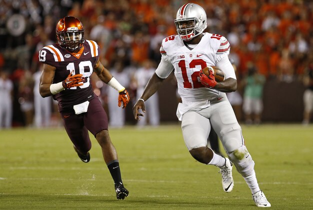 Sep 7, 2015; Blacksburg, VA, USA; Ohio State Buckeyes quarterback Cardale Jones (12) runs with the ball as Virginia Tech Hokies cornerback Chuck Clark (19) chases in the first quarter at Lane Stadium. Mandatory Credit: Geoff Burke-USA TODAY Sports