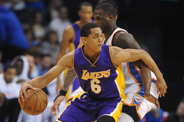 Mar 24, 2015; Oklahoma City, OK, USA; Los Angeles Lakers guard Jordan Clarkson (6) handles the ball against Oklahoma City Thunder guard Dion Waiters (23) during the fourth quarter at Chesapeake Energy Arena. Mandatory Credit: Mark D. Smith-USA TODAY Sports