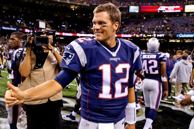Aug 22, 2015; New Orleans, LA, USA; New England Patriots quarterback Tom Brady (12) gives a thumbs up to New Orleans Saints quarterback Drew Brees (not pictured) following a preseason game at the Mercedes-Benz Superdome. The Patriots defeated the Saints 26-24. Mandatory Credit: Derick E. Hingle-USA TODAY Sports