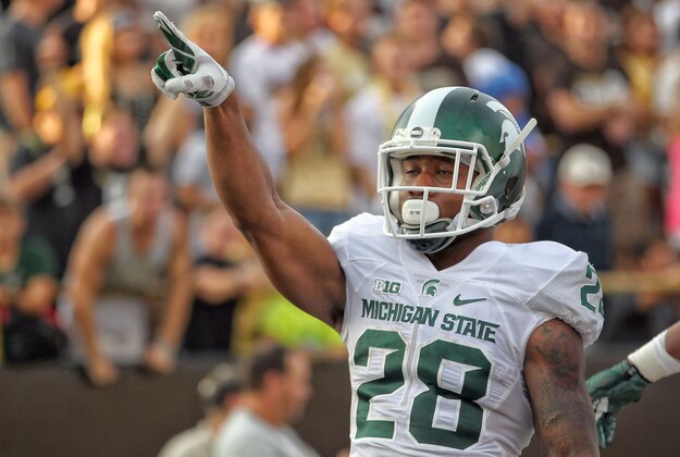 Sep 4, 2015; Kalamazoo, MI, USA; Michigan State Spartans running back Madre London (28) celebrates a touchdown against the Western Michigan Broncos prior to a game at Waldo Stadium. Mandatory Credit: Mike Carter-USA TODAY Sports
