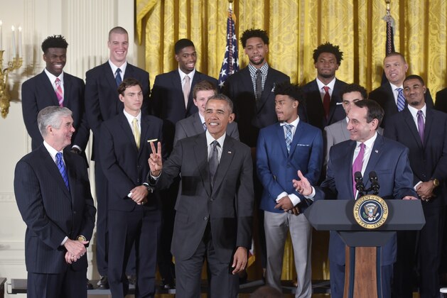 US President Barack Obama holds up two fingers to indicate the number of times that the Duke basketball team has been honored at the White House as head coach Mike Krzyzewski (R) speaks during an event in honor of the Duke Blue Devils Mens Basketball team and their 2015 NCAA Championship victory on September 8, 2015 in the East Room of the White House in Washington, DC. AFP PHOTO/MANDEL NGAN        (Photo credit should read MANDEL NGAN/AFP/Getty Images)