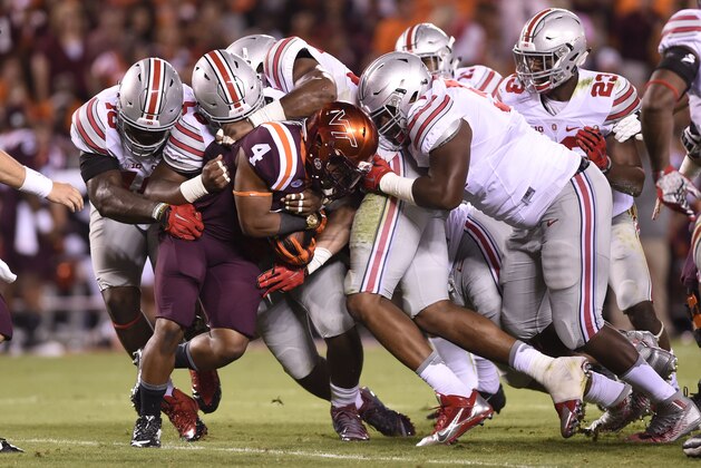 Sep 7, 2015; Blacksburg, VA, USA; Virginia Tech Hokies running back J.C. Coleman (4) is gang tackled at Lane Stadium. Mandatory Credit: Bob Donnan-USA TODAY Sports