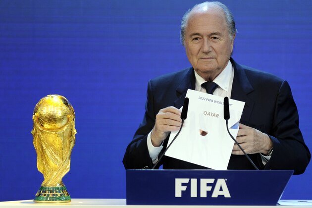 FIFA President Sepp Blatter holds up the name of Qatar during the official announcement of the 2022 World Cup host country on December 2, 2010  at the FIFA headquarters  in Zurich. South Korea, Japan, Australia, Qater and the US were all bidding to host the 2022 World Cup.  AFP PHOTO / PHILIPPE DESMAZES        (Photo credit should read PHILIPPE DESMAZES/AFP/Getty Images)