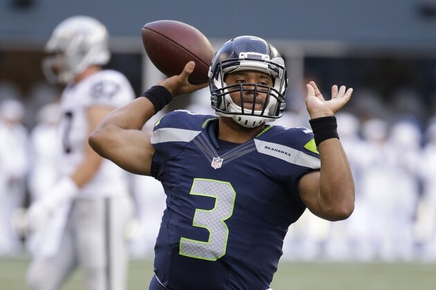 Seattle Seahawks quarterback Russell Wilson throws the ball before a preseason NFL football game against the Oakland Raiders, Thursday, Sept. 3, 2015, in Seattle. (AP Photo/Elaine Thompson)