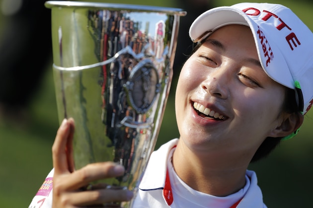 Hyo Joo Kim of South Korea poses for photographers with her trophy after winning the Evian Championship women's golf tournament in Evian, eastern France, Sunday Sept. 14, 2014. (AP Photo/Laurent Cipriani)