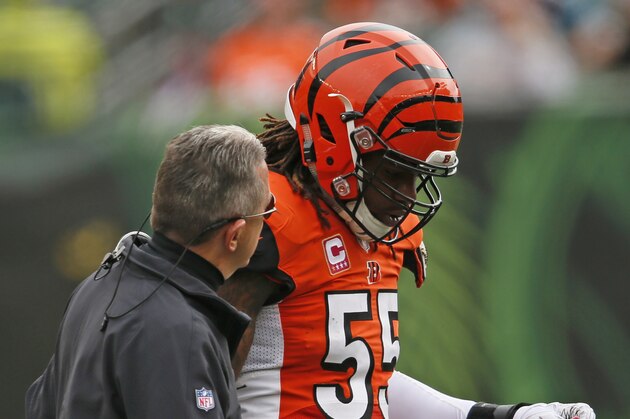 Cincinnati Bengals outside linebacker Vontaze Burfict (55) walks off the field with trainer Paul Sparling in the first half of an NFL football game against the Carolina Panthers, Sunday, Oct. 12, 2014, in Cincinnati. (AP Photo/Paul Sancya)