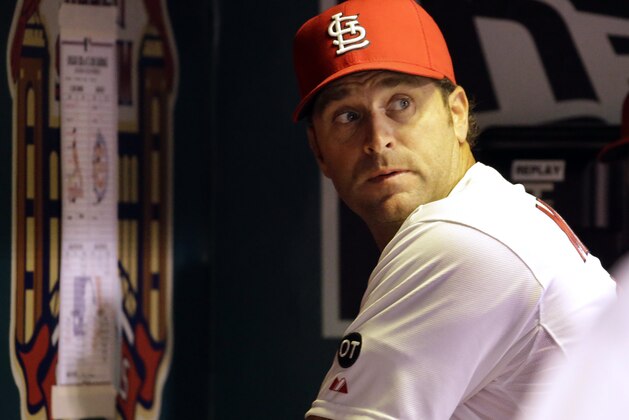 St. Louis Cardinals manager Mike Matheny looks over his shoulder toward the field after looking at a line-up card taped to the dugout wall during the fourth inning of the Cardinals' baseball game against the Chicago Cubs on Tuesday, Sept. 8, 2015, in St. Louis. (AP Photo/Jeff Roberson)