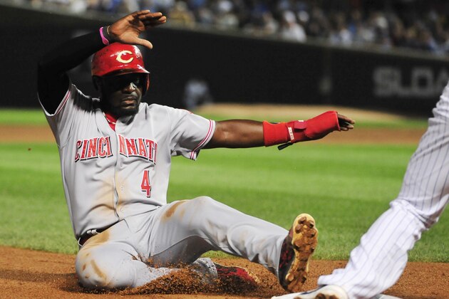 CHICAGO, IL - SEPTEMBER 01: Brandon Phillips #4 of the Cincinnati Reds steals third base against the Cincinnati Reds during the sixth inning on September 1, 2015 at Wrigley Field in Chicago, Illinois. (Photo by David Banks/Getty Images)