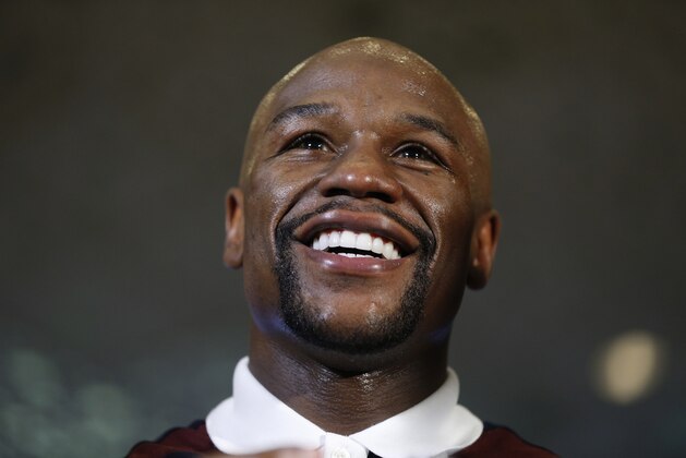 Floyd Mayweather Jr. stands on stage during a grand arrival for his upcoming fight Tuesday, Sept. 8, 2015, in Las Vegas. Mayweather is scheduled to fight Andre Berto in a welterweight title bout Saturday in Las Vegas. (AP Photo/John Locher)