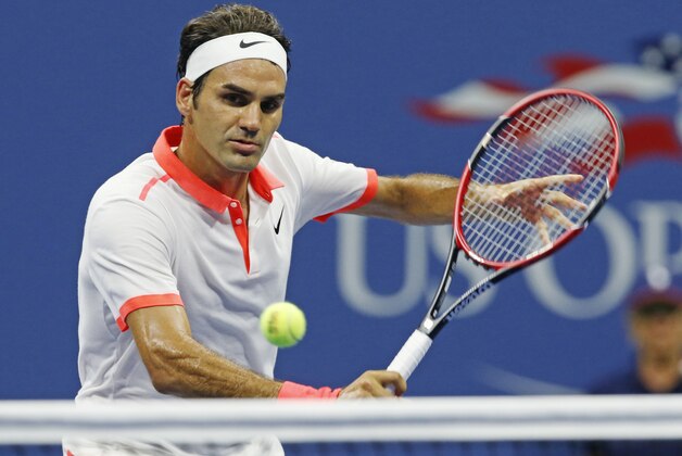 Roger Federer, of Switzerland, hits during his fourth round match against John Isner at the U.S. Open tennis tournament in New York, Monday, Sept. 7, 2015.  (AP Photo/Kathy Willens)