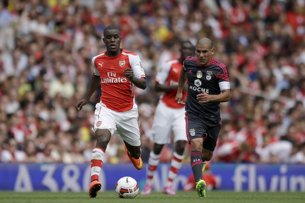 Making his debut Arsenal's Joel Campbell competes for the ball with Benfica's Maxi Pereira, right, during the Emirates Cup soccer match between between Arsenal and Benfica at Arsenal's Emirates Stadium in London, Saturday, Aug. 2, 2014.  (AP Photo/Matt Dunham)