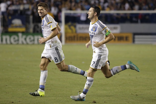Los Angeles Galaxy's Robbie Keane, right, of Ireland, celebrates his goal with Steven Gerrard, of England, during the second half of an MLS soccer match against the San Jose Earthquakes, Friday, July 17, 2015, in Carson, Calif. The Galaxy won 5-2. (AP Photo/Jae C. Hong)