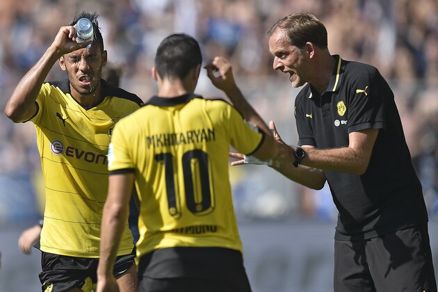 Dortmund head coach Thomas Tuchel, right, talks to Dortmund's Pierre-Emerick Aubameyang, left,  as he  refreshes with water  during the German Bundesliga soccer match between Borussia Dortmund and Hertha BSC Berlin in Dortmund, Germany, Sunday, Aug. 30, 2015. (AP Photo/Martin Meissner)