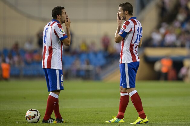 Atletico Madrid's midfielder Koke and Atletico Madrid's midfielder and captain Gabi gesture during the Spanish league football match Club Atletico de Madrid vs S.D Eibar at the Vicente Calderon stadium in Madrid on August 30, 2014.   AFP PHOTO/ DANI POZO        (Photo credit should read DANI POZO/AFP/Getty Images)