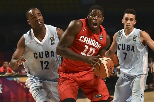 Canada's power forward Anthony Bennett (C) dribbles past Cuba's centre Yoan Haiti (L) and point guard Yaser Rodriguez (R) during a 2015 FIBA Americas Championship Men's Olympic qualifying match at the Sport Palace in Mexico City on September 2, 2015. Canada won 101-59. AFP PHOTO/ Yuri CORTEZ        (Photo credit should read YURI CORTEZ/AFP/Getty Images)