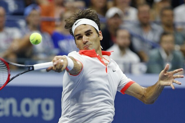 Roger Federer, of Switzerland, returns the ball during a second set tiebreak in his fourth round match against John Isner at the U.S. Open tennis tournament in New York, Monday, Sept. 7, 2015.  (AP Photo/Kathy Willens)