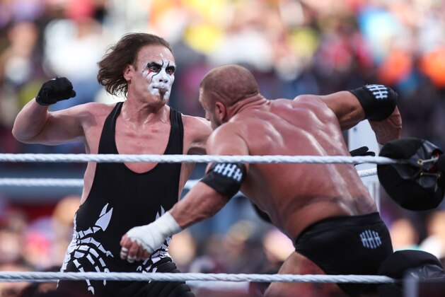 WWE wrester Sting punches his opponent Triple H at Wrestlemania XXXI, on Sunday, March 29, 2015 in Santa Clara, CA. 2015 marks the first year Wrestlemania will be held in the San Francisco Bay Area, being made available to viewers in 177 countries via the WWE Network. (Don Feria/AP Images for WWE)