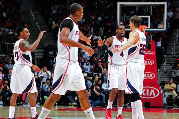 ATLANTA, GA - JANUARY 21:Jeff Teague #0, Al Horford #15, Paul Millsap #4, and Kyle Korver #26 of the Atlanta Hawks celebrate after a score against the Indiana Pacers on January 21, 2015 at Philips Arena in Atlanta, Georgia.  NOTE TO USER: User expressly acknowledges and agrees that, by downloading and/or using this Photograph, user is consenting to the terms and conditions of the Getty Images License Agreement. Mandatory Copyright Notice: Copyright 2015 NBAE (Photo by Scott Cunningham/NBAE via Getty Images)