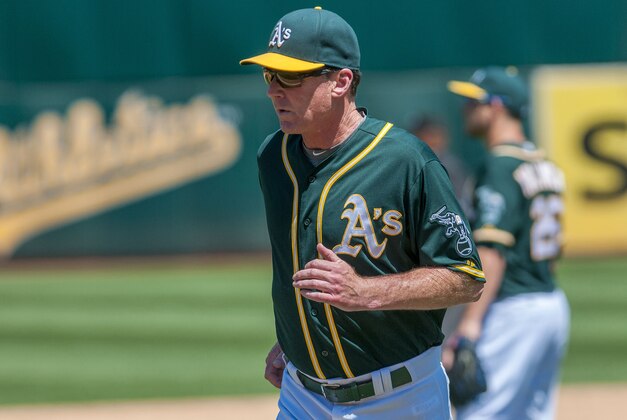 Aug 5, 2015; Oakland, CA, USA; Oakland Athletics manager Bob Melvin (6) returns to the dugout after making a pitching change during the sixth inning of the game against the Baltimore Orioles at O.co Coliseum. Mandatory Credit: Ed Szczepanski-USA TODAY Sports