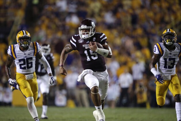 Mississippi State quarterback Dak Prescott (15) rushes for a touchdown in the second half of an NCAA college football game against LSU in Baton Rouge, La., Saturday, Sept. 20, 2014. (AP Photo/Gerald Herbert)