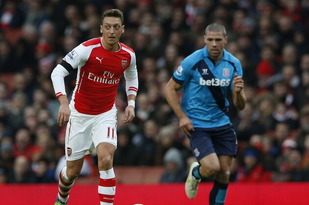 Arsenal's Mesut Ozil looks up as he goes to pass the ball forward during the English Premier League soccer match between Arsenal and Stoke City at the Emirates  stadium in London, Sunday, Jan. 11,  2015. (AP Photo/Alastair Grant)