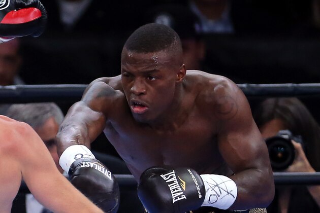 Apr 11, 2015; Brooklyn, NY, USA; Peter Quillin  punches Andy Lee (black and red gloves) during their middleweight fight at Barclays Center. Mandatory Credit: Adam Hunger-USA TODAY Sports