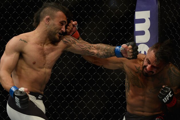 LAS VEGAS, NV - SEPTEMBER 05: (L-R) John Lineker and Francisco Rivera exchange punches in their bantamweight bout during the UFC 191 event inside MGM Grand Garden Arena on September 5, 2015 in Las Vegas, Nevada.  (Photo by Brandon Magnus/Zuffa LLC/Zuffa LLC via Getty Images)