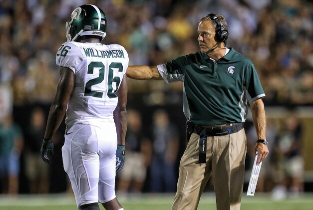 Sep 4, 2015; Kalamazoo, MI, USA; Michigan State Spartans head coach Mark Dantonio talks to safety Rj Williamson (26) during the 2nd half of a game at Waldo Stadium. Mandatory Credit: Mike Carter-USA TODAY Sports