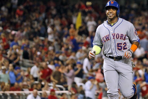 New York Mets' Yoenis Cespedes (52) smiles as he comes home for his two-run homer during the eighth inning of a baseball game against the Washington Nationals at Nationals Park, Wednesday, Sept. 9, 2015, in Washington.  The Mets won 5-3. (AP Photo/Alex Brandon)