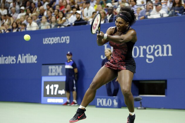 Serena Williams returns a shot to Venus Williams during a quarterfinal match at the U.S. Open tennis tournament, Tuesday, Sept. 8, 2015, in New York. (AP Photo/Julio Cortez)