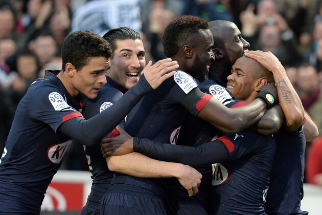 Bordeaux's Uruguyan forward Diego Rolan (R) celebrates with teammates after scoring a goal during the French L1 football match between Bordeaux (FCGB) and Paris Saint-Germain (PSG) on March 15, 2015 at the Chaban-Delmas Stadium in Bordeaux, southwestern France. AFP PHOTO / JEAN-PIERRE MULLER        (Photo credit should read JEAN-PIERRE MULLER/AFP/Getty Images)