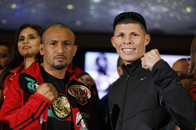 Roman Martinez, right, and Orlando Salido pose for photographers at the grand arrival  Tuesday, Sept. 8, 2015, in Las Vegas. The two are scheduled to fight in a lightweight title bout Saturday in Las Vegas. (AP Photo/John Locher)