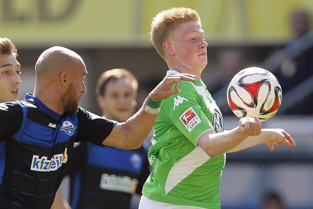 FILE - This is a Sunday, May 10, 2015 file photo of Wolfburg's Kevin De Bruyne from Belgium, right, as he is challenged by Paderborn's Daniel Brueckner during the German first division Bundesliga soccer match in Paderborn, Germany. Kevin de Bruyne has joined Manchester City from Wolfsburg for a reported fee of 58 million pounds ($89 million), making the Belgium midfielder the second most expensive player in the history of English football. City announced the transfer on Sunday Aug 30, 2015, saying the 24-year-old De Bruyne has signed a six-year deal. (AP Photo/Frank Augstein, File) FILE - This is a Sunday, May 10, 2015 file photo of Wolfburg's Kevin De Bruyne from Belgium, right, as he is challenged by Paderborn's Daniel Brueckner during the German first division Bundesliga soccer match in Paderborn, Germany. Kevin de Bruyne has joined Manchester City from Wolfsburg for a reported fee of 58 million pounds ($89 million), making the Belgium midfielder the second most expensive player in the history of English football. City announced the transfer on Sunday Aug 30, 2015, saying the 24-year-old De Bruyne has signed a six-year deal. (AP Photo/Frank Augstein, File)