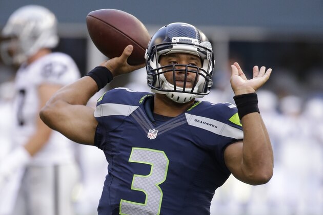 Seattle Seahawks quarterback Russell Wilson throws the ball before a preseason NFL football game against the Oakland Raiders, Thursday, Sept. 3, 2015, in Seattle. (AP Photo/Elaine Thompson)