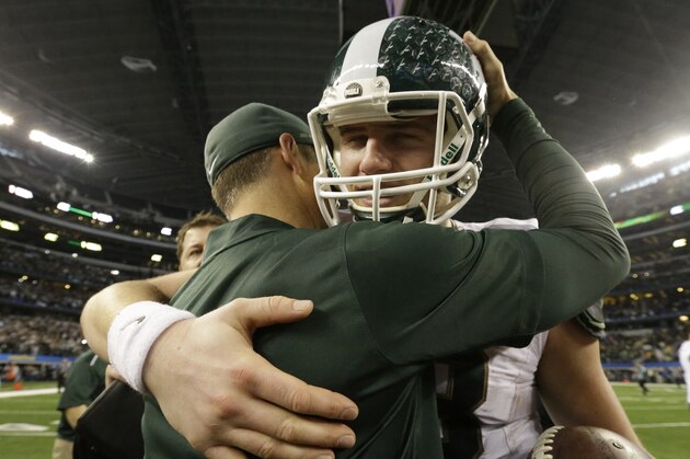 Michigan State quarterback Connor Cook his hugged after the Cotton Bowl NCAA college football game against Baylor Thursday, Jan. 1, 2015, in Arlington, Texas.  Michigan State  won 42-41. (AP Photo/LM Otero)