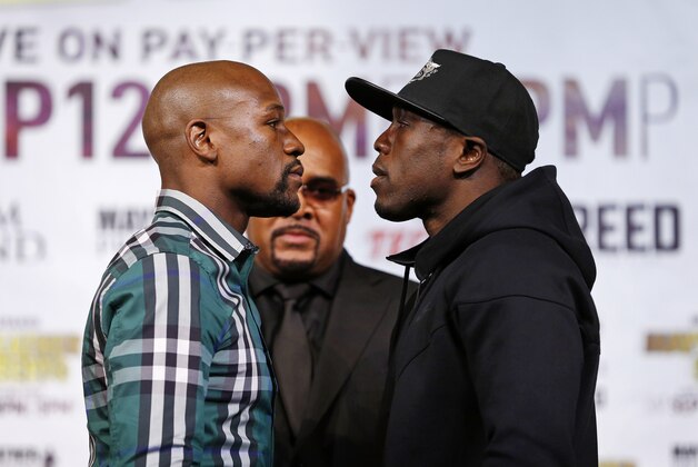 Boxers Floyd Mayweather Jr., left, and Andre Berto pose for photographers during a news conference Wednesday, Sept. 9, 2015, in Las Vegas. The pair are scheduled to fight Saturday for Mayweather's WBC and WBA Super World welterweight titles.   (AP Photo/John Locher)