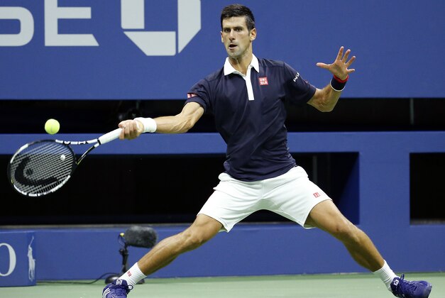 Novak Djokovic, of Serbia, returns a shot to Feliciano Lopez, of Spain, during the quarterfinals of the U.S. Open tennis tournament in New York, Wednesday, Sept. 9, 2015. (AP Photo/Julio Cortez)