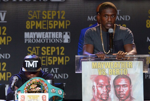 Aug 6, 2015; Los Angeles, CA, USA; Andre Berto speaks to the media as Floyd Mayweather, Jr. listens during a press conference to announce the upcoming fight on September 12, 2015 at J.W. Marriott LA Live. Mandatory Credit: Jayne Kamin-Oncea-USA TODAY Sports