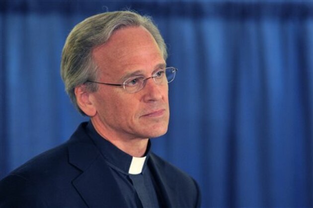 Rev. John I. Jenkins, C.S.C. the University's President, left,  talks about the academic scandal Friday Aug. 15, 2014 in South Bend, Ind. Notre Dame says it is investigating