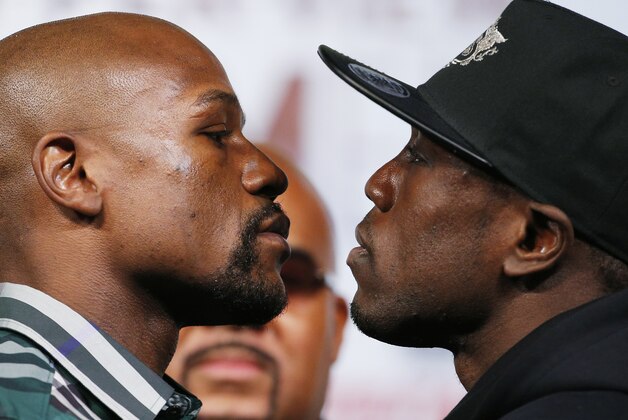 Floyd Mayweather Jr., left, and Andre Berto pose for photographers during a news conference Wednesday, Sept. 9, 2015, in Las Vegas. The two are scheduled to fight Saturday in Las Vegas. (AP Photo/John Locher)