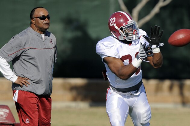 Alabama running back Mark Ingram makes a catch as associate head and running backs coach Burton Burns looks on during practice, Saturday, Jan. 2, 2010, in Costa Mesa, Calif., in preparation for their BCS Championship NCAA college football game against Texas. The game is scheduled for Thursday, Jan. 7. (AP Photo/Mark J. Terrill)