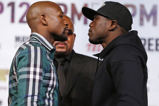 Floyd Mayweather Jr., left, and Andre Berto pose for photographers during a news conference Wednesday, Sept. 9, 2015, in Las Vegas. The two are scheduled to fight Saturday in Las Vegas. (AP Photo/John Locher)