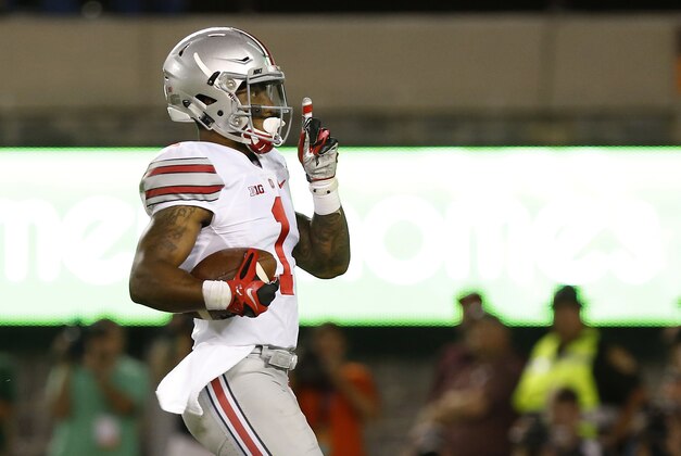 Sep 7, 2015; Blacksburg, VA, USA; Ohio State Buckeyes wide receiver Braxton Miller (1) gestures to the crowd while running with the ball enroute to scoring a touchdown against the Virginia Tech Hokies in the third quarter at Lane Stadium. Mandatory Credit: Geoff Burke-USA TODAY Sports