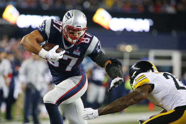 New England Patriots tight end Rob Gronkowski (87) shakes off Pittsburgh Steelers safety Robert Golden (21) as he heads for a touchdown after catching a pass in the first half of an NFL football game, Thursday, Sept. 10, 2015, in Foxborough, Mass. (AP Photo/Winslow Townson)