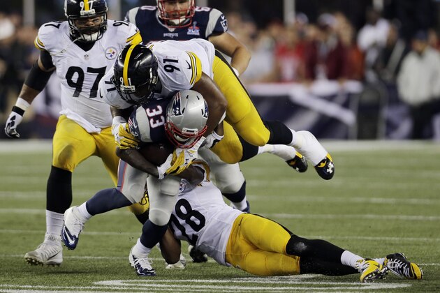 Pittsburgh Steelers defensive end Stephon Tuitt (91) and cornerback Cortez Allen (28) tackle New England Patriots running back Dion Lewis (33) in the first half of an NFL football game, Thursday, Sept. 10, 2015, in Foxborough, Mass. (AP Photo/Charles Krupa)