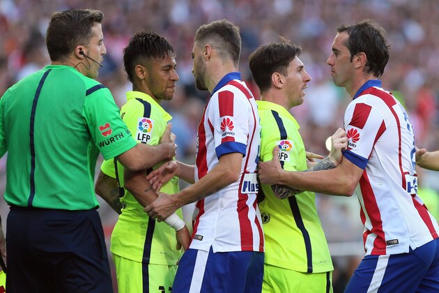 Barcelona's Brazilian forward Neymar da Silva Santos Junior (2nd L) and Barcelona's Argentinian forward Lionel Messi (2nd R) argue with Atletico Madrid's Brazilian defender Guilherme Siqueira (C) and Atletico Madrid's midfielder Juanfran (R) during the Spanish league football match Club Atletico de Madrid vs FC Barcelona at the Vicente Calderon stadium in Madrid on May 17, 2015.   AFP PHOTO / CESAR MANSO        (Photo credit should read CESAR MANSO/AFP/Getty Images)