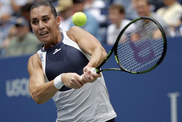 Flavia Pennetta, of Italy, returns a shot to Simona Halep, of Romania, during a semifinal match at the U.S. Open tennis tournament, Friday, Sept. 11, 2015, in New York. (AP Photo/Bill Kostroun)
