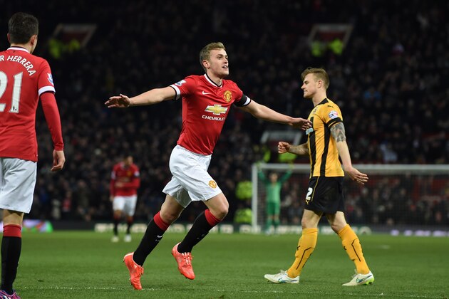 Manchester United's English striker James Wilson celebrates scoring their third goal during the FA Cup fourth round replay football match between Manchester United and Cambridge United at Old Trafford in Manchester, north west England, on February 3, 2015. AFP PHOTO / PAUL ELLIS 

== RESTRICTED TO EDITORIAL USE. No use with unauthorized audio, video, data, fixture lists, club/league logos or live services. Online in-match use limited to 45 images, no video emulation. No use in betting, games or single club/league/player publications.  ==        (Photo credit should read PAUL ELLIS/AFP/Getty Images)