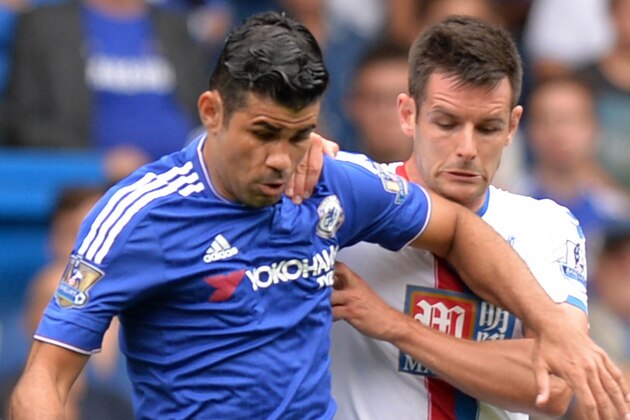 Chelsea's Brazilian-born Spanish striker Diego Costa (L) vies with Crystal Palace's English defender Scott Dann during the English Premier League football match between Chelsea and Crystal Palace at Stamford Bridge in London on August 29, 2015. AFP PHOTO / OLLY GREENWOOD

RESTRICTED TO EDITORIAL USE. No use with unauthorized audio, video, data, fixture lists, club/league logos or 'live' services. Online in-match use limited to 75 images, no video emulation. No use in betting, games or single club/league/player publications.        (Photo credit should read OLLY GREENWOOD/AFP/Getty Images)